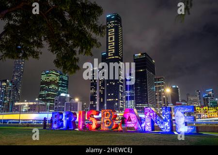 Brisbane artwork sign at Southbank Parklands with Brisbane CBD skyline in background, Brisbane, Australia Stock Photo