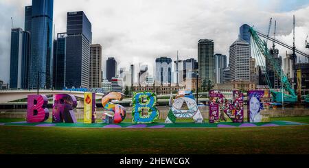 Brisbane artwork sign at Southbank Parklands with Brisbane CBD skyline in background, Brisbane, Australia Stock Photo