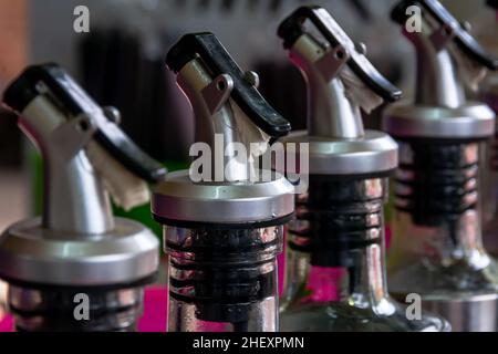 line of professional stainless steel bottles cap of syrup from the street food bar vendor Stock Photo