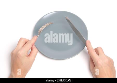 Empty plate and hands with cutlery spoon and fork white background Stock Photo