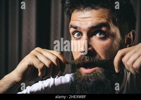 Funny man with long moustache. Bearded man with mustache, bearded excited gay. Stock Photo