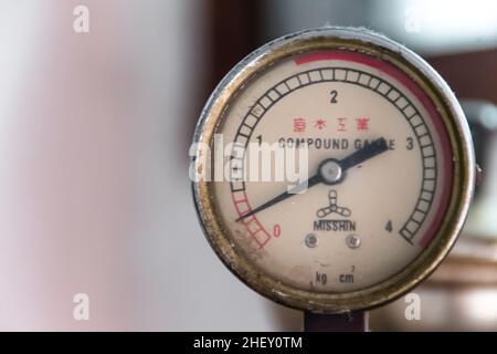 Close-up of industrial stainless preassure meter from garment industry iron steamer machine with blurry and soft focus background Stock Photo