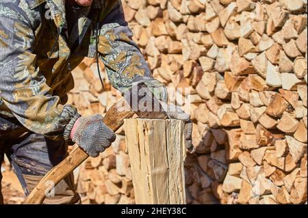 chopping firewood with a chopper close-up on a sunny day Stock Photo