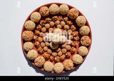 Many types of ladoo like Amaranth ladoo or Rajgira, Puffed rice or mamra, Peanut laddu, til sesame laddo, tilgur mawa white sweet balls. Sankrant or U Stock Photo