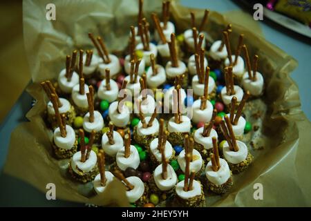 marshmallows on a sticks, glazed with chocolate and colorful sprinkles  Stock Photo