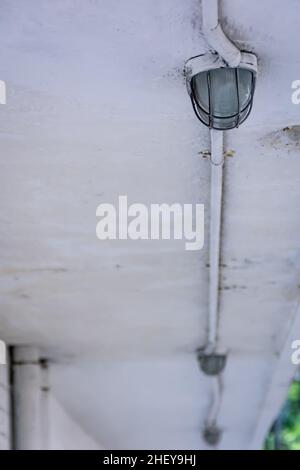 Line of iron industrial lights on the white ceiling Stock Photo