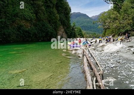 People at lunch on a white water rafting trip on the Upper Grey river, south island, New Zealand. Stock Photo