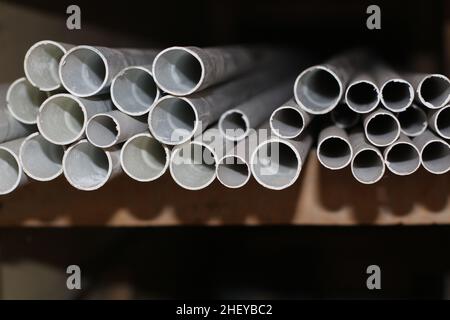 the pile of paralon pipes on wooden shelves Stock Photo
