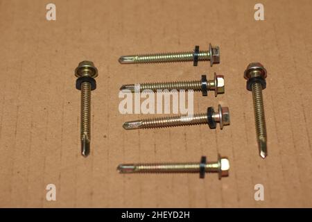 roof bolts isolated on brown background Stock Photo