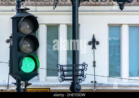 Decorated vintage and old traffic green light with retro concept metal work design on the heritage city street at Bandung Stock Photo