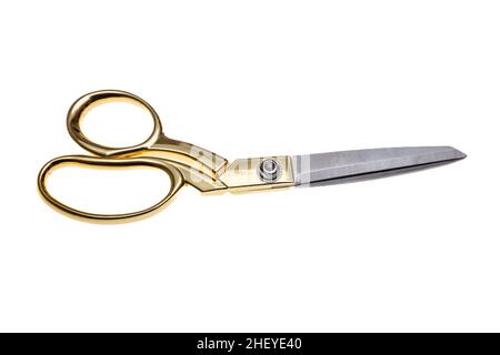 Scissors with golden handle isolated cutout on white background. Tailor, barber professional equipment Stock Photo