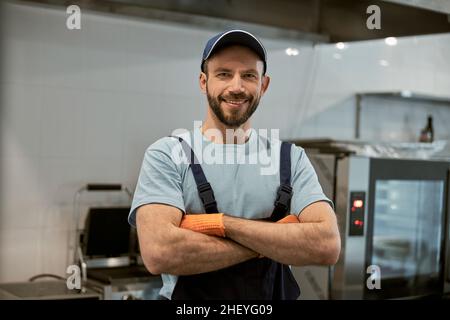 Cheerful male worker looking at camera and smiling Stock Photo