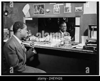 Portrait of musician Louis Armstrong, Aquarium, New York, N.Y., ca. July 1946. 'Satchmo' portrait, looking in the mirror. Photo by William Gottlieb. Stock Photo