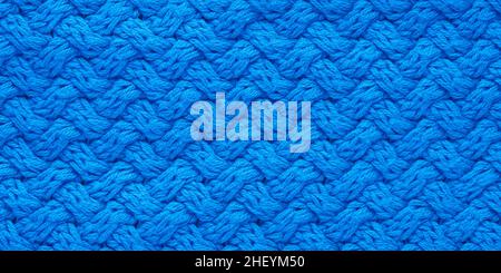 Dark blue knitted texture. Abstract background, pattern. Detail of a warm winter sweater Stock Photo