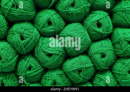 Green Ball of wool. Beautiful colored wools ball. Wool texture. Skeins of yarn. Natural material for knitting, creative idea. Abstract diy background. Stock Photo