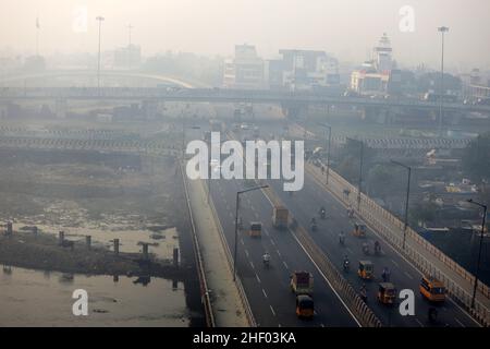 Chennai, Tamil Nadu, India. 13th Jan, 2022. The city was seen enveloped with severe smog as a result of the Bhogi Bonfire in Chennai. Bhogi is the first day of the four-day Makara Sankranti festival. On Bhogi, people discard old and derelict things and concentrate on new things causing change or transformation. People light bonfires with logs of wood, old clothes, and wooden furniture at home that are no longer useful. (Credit Image: © Sri Loganathan/ZUMA Press Wire) Stock Photo