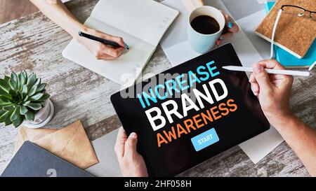 Increase brand awareness text on screen. Advertising and marketing concept. Stock Photo