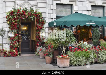 The Ivy Market Grill - restaurant floral facade outside seating in Covent Garden London UK. Stock Photo