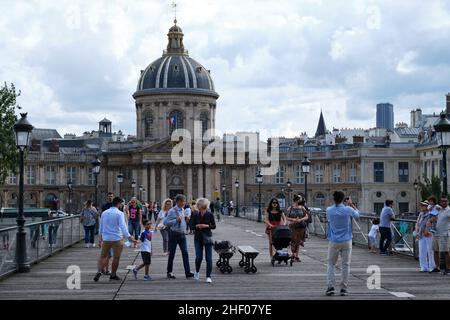 Paris: Tourists on the bridge Pont des Arts over the Seine. Stock Photo