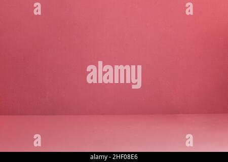 Pink-red textured wall with some small white spots and dirt. Artistic painted background. Abstract art. Stock Photo
