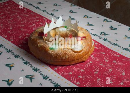 Traditional round or oval-shaped cake with a sweet creamy filling inside and candied fruit adorning the top gives off the appearance of a jeweled crow Stock Photo