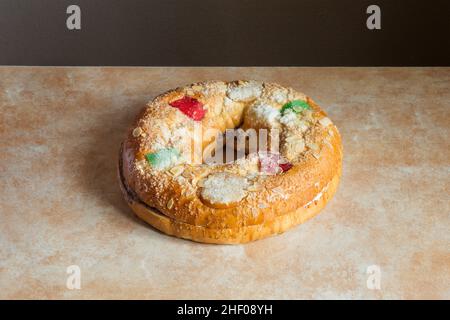 Large donut cake filling with sweet whipped cream with candied fruit adorning the top on an abstract watercolor background. Traditional sweet food on Stock Photo