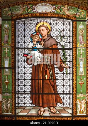 ROME, ITALY - AUGUST 30, 2021: The St. Anthony of Padua in the stained glass in the church Sant'Antonio dei Portoghesi. Stock Photo