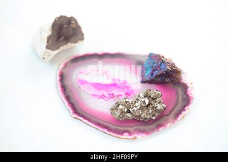 Composition of semi precious stones  on bright background. Collection of beautiful stones: agate, pyrite, chalcopyrite. Home decoration, geology hobby Stock Photo