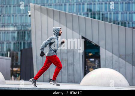 Young man running in the city Stock Photo