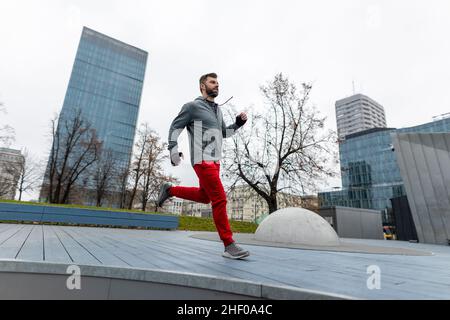 Young man running in the city Stock Photo
