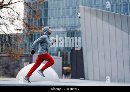 Young man running in the city Stock Photo