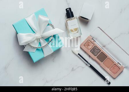 Barcelona, Spain - January 2022. Tiffany and Co gift box with heart bracelet, perfume bottle, eyeshadow palette flat lay top view. Luxury, jewelry Stock Photo