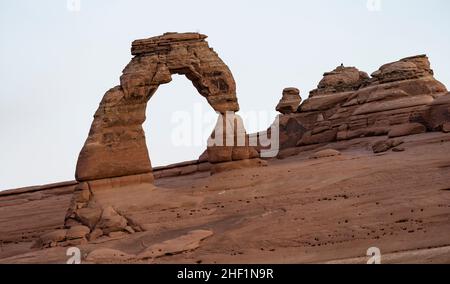 Delicate Arch in Arches National Park, seen from Upper Delicate Arch Viewpoint before sunrise. Stock Photo
