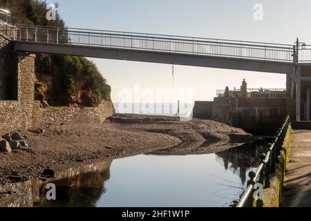Silt building up across the mouth of the River Sid as it reaches the sea under the new Alma Bridge, on the South West Coastal Path at Sidmouth, Devon Stock Photo