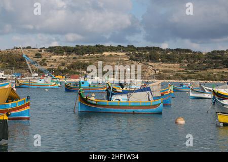 View of the fishing harbor with colorful boats docked near the shore ...