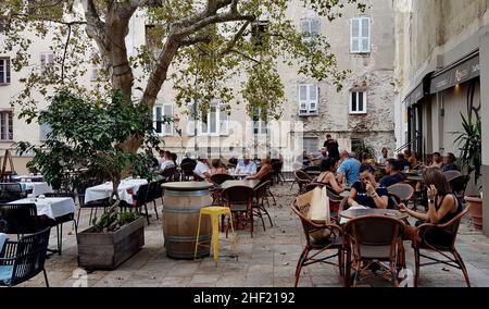 Bastia, Corsica, 17.08.2020. Outdoor restaurant on square in old town of Bastia, Corsica, France. Stock Photo