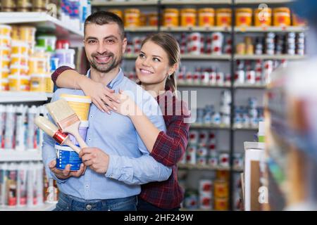Two designer are holding paint and brushes Stock Photo