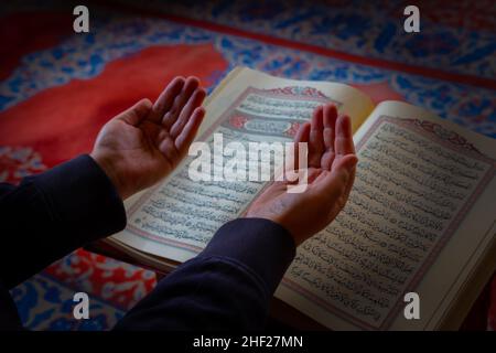 Praying muslim man. Muslim man praying by raising the hands Stock Photo