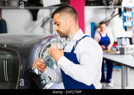 Mechanic performing dents repair Stock Photo