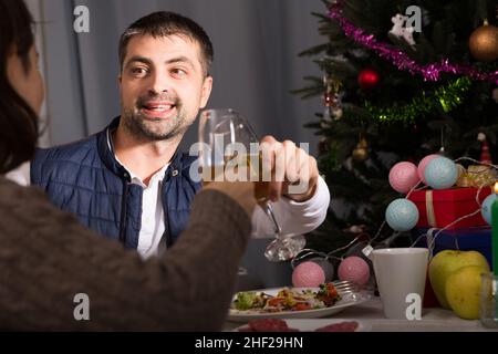 Couple having christmas dinner and watching tv Stock Photo