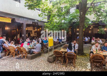 SARAJEVO, BOSNIA AND HERZEGOVINA - JUNE 12, 2019: Open air cafe in Bascarsija disctrict of Sarajevo. Bosnia and Herzegovina Stock Photo