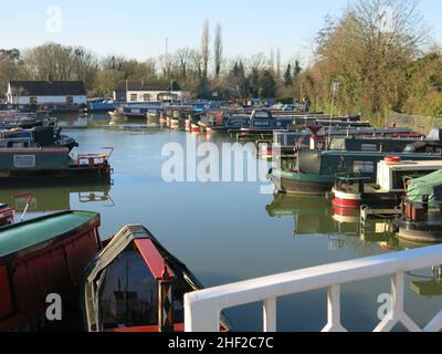 Bright winter sunshine at Braunston Marina on the Grand Union Canal, with a colourful array of narrowboats at their moorings. Stock Photo