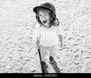 Funny kid baseball player in baseball helmet and baseball bat