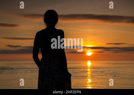 silhouette of female holding sun on the beach Stock Photo - Alamy