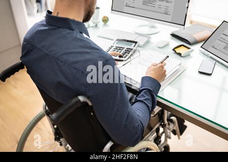 Accountant Using E Invoice Software At Computer In Office Stock Photo