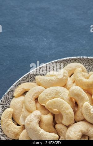Cashew nuts on a silver plate, selective focus. Stock Photo