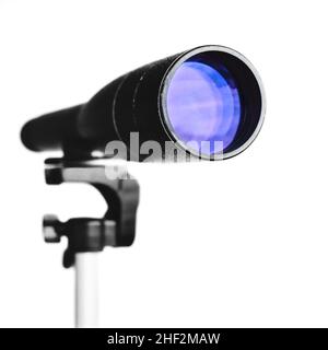 Spyglass or telescope on tripod isolated on white background. Close-up view on telescope lens. Selective focus. Stock Photo