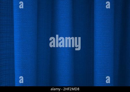Close-up of fabric blue curtains with folds . Abstract background, curtain, drapes blue fabric. Stock Photo