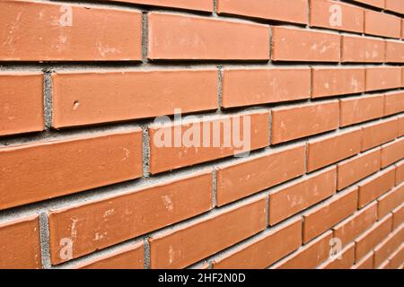 Red brick wall in perspective. Masonry brickwork background. Abstract backdrop. Stock Photo