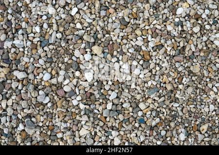 Small multi-colored stones as background. Abstract natural texture. Stones pattern. Stock Photo